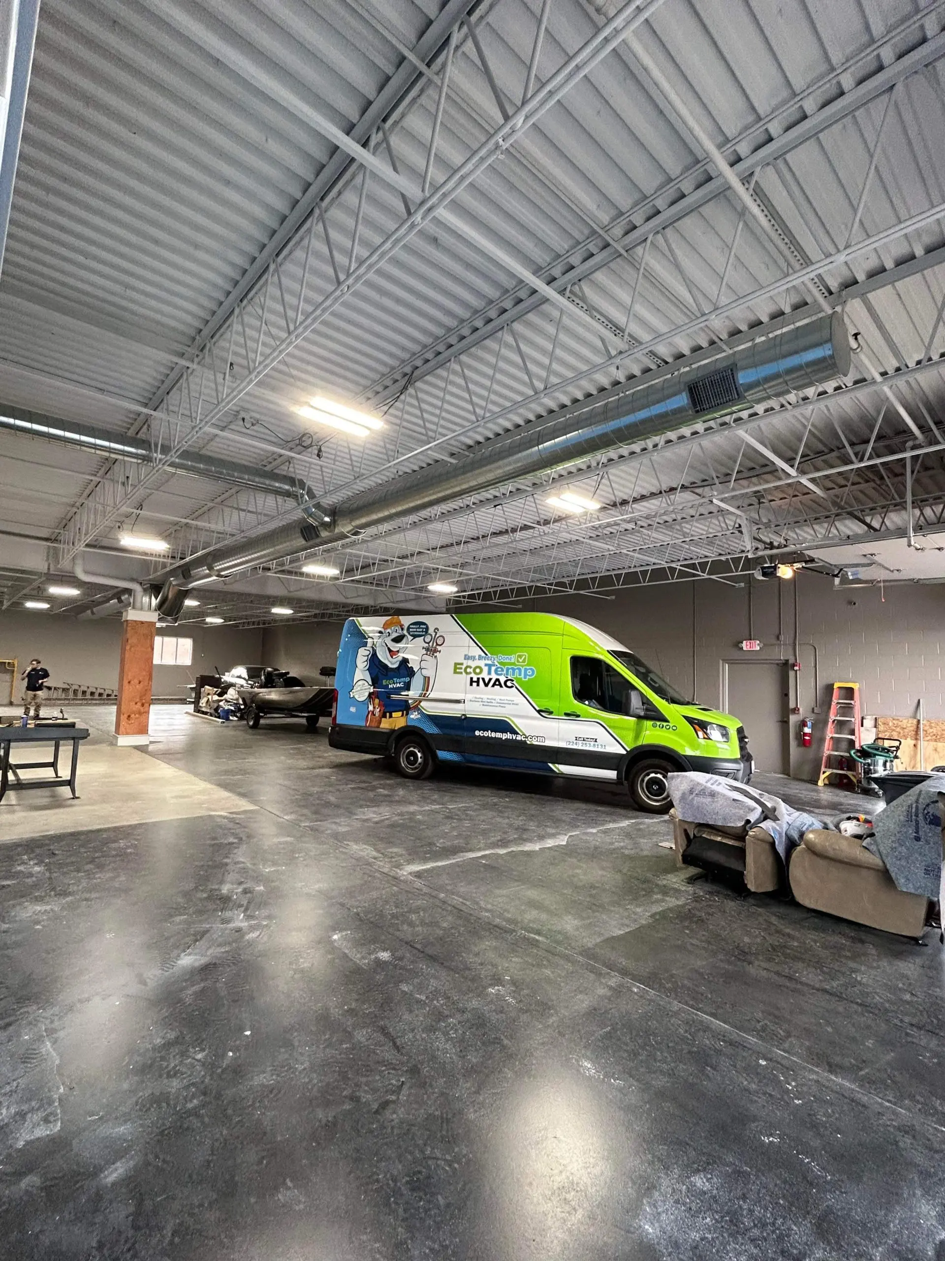 An HVAC technician van parked inside a garage.