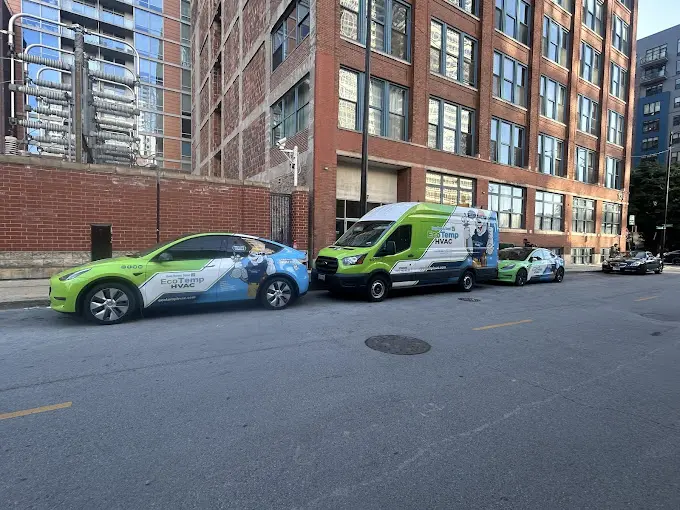 Three Eco Temp HVAC branded service vehicles in front of a commercial building in Chicago.