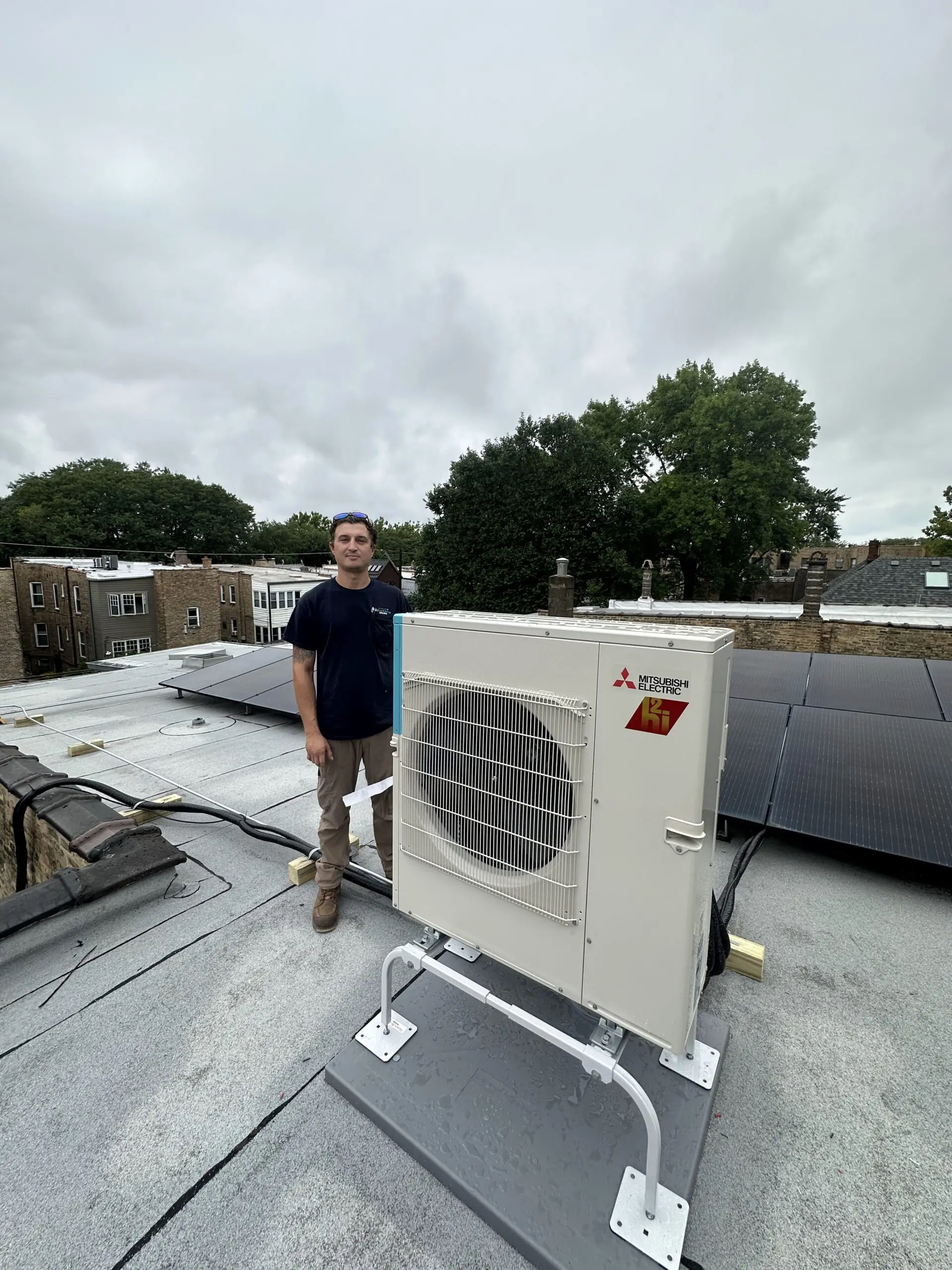HVAC technician performing maintenance on a modern heating and cooling system in Hampshire, IL, highlighting Eco Temp HVAC's expertise.