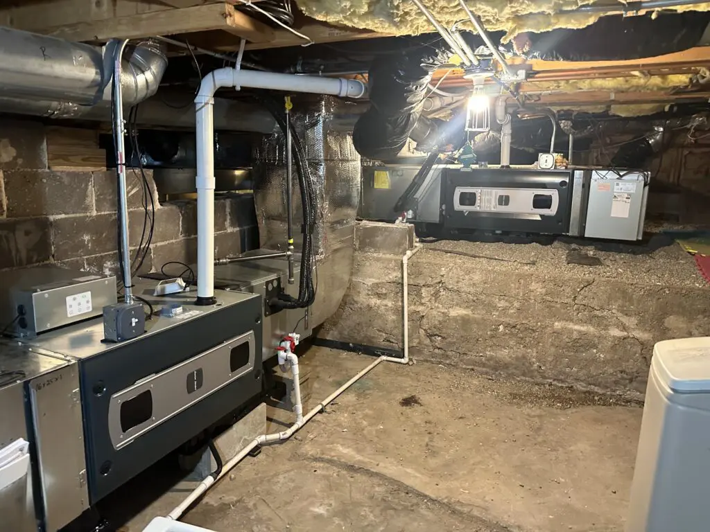 New high-efficiency furnace installation in Chicago crawl space by Eco Temp HVAC technician
